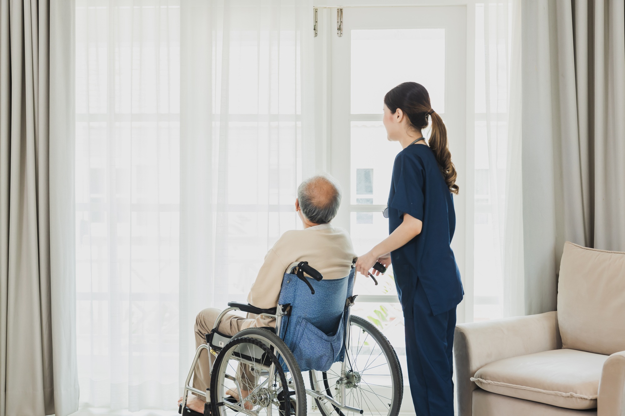 Senior man in wheelchair receives medical help for injury
